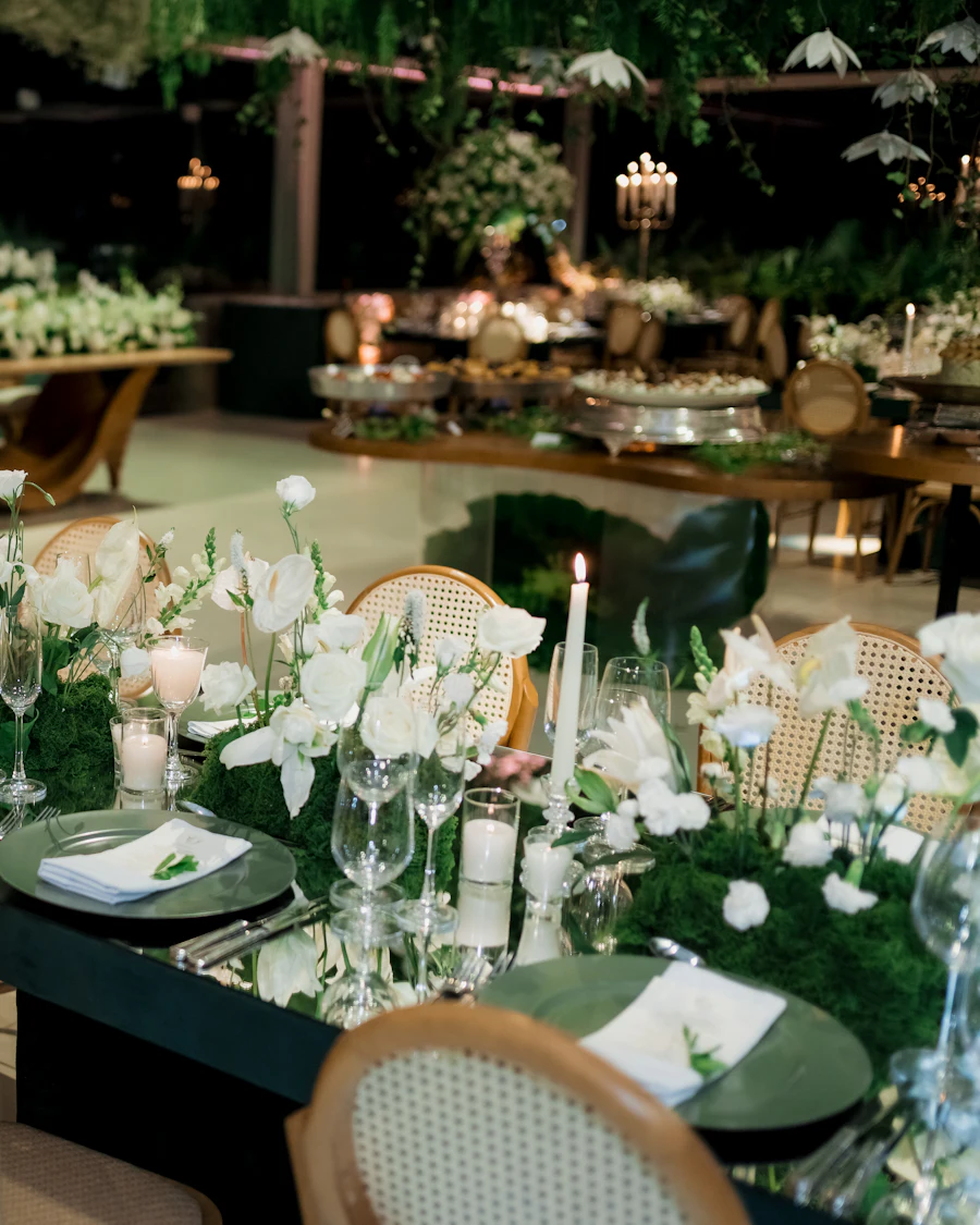 A candlelit reception table with white flowers