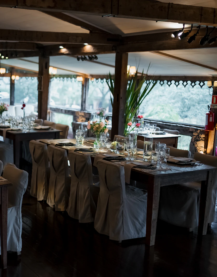 A dim, elegant dining room with set tables